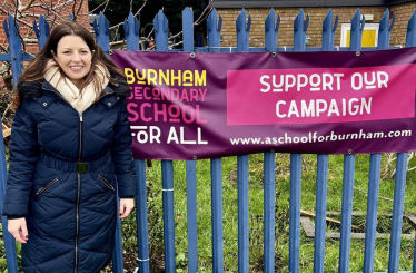 Joy in front of Burnham School campaign banner